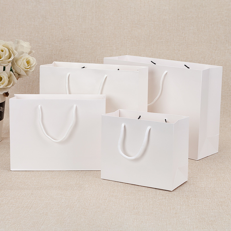 White card film coated paper bag clothing packaging handbag in stock gift bag printing gift shopping bag logo hand carry