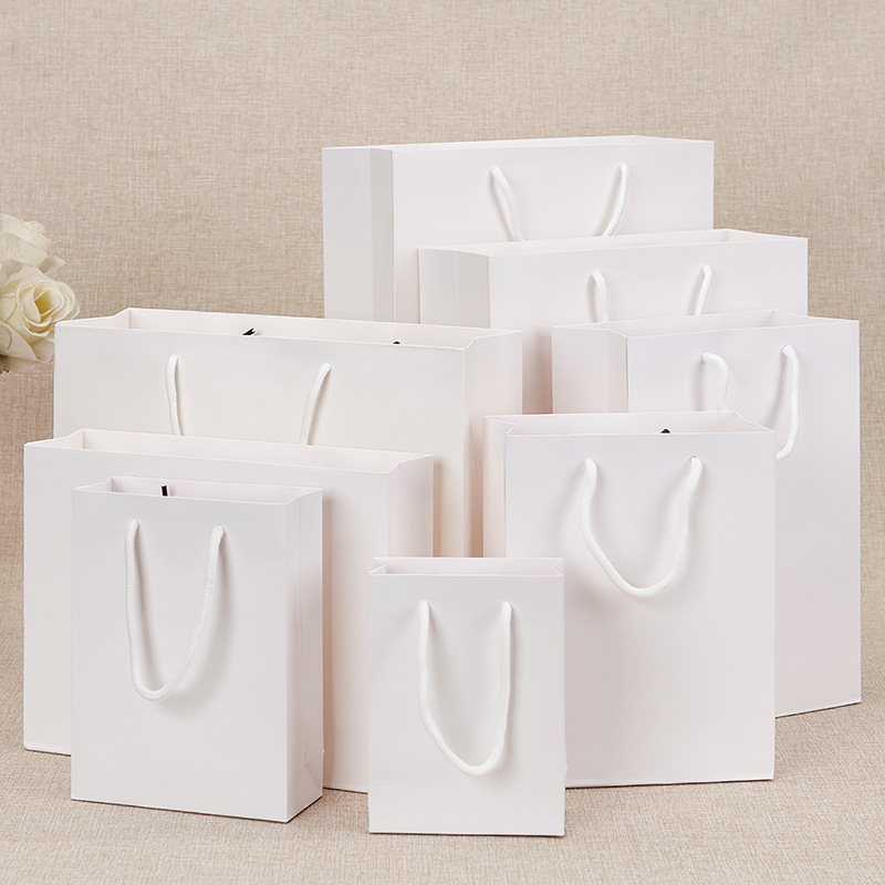 White card film coated paper bag clothing packaging handbag in stock gift bag printing gift shopping bag logo hand carry