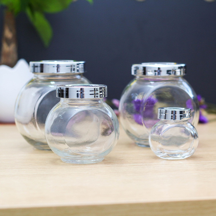 Factory wholesale 180ml flat drum storage tank Lycium ruthenicum packaging bottle glass bottle candy bottle honey bottle with lid