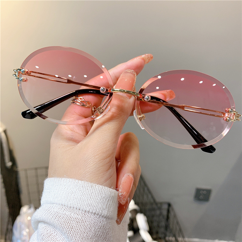 Nuevas gafas de sol transfronterizas para mujer, gafas de sol con degradado rojo ovalado en red, sin marco, gafas de moda al por mayor_voghion.com
