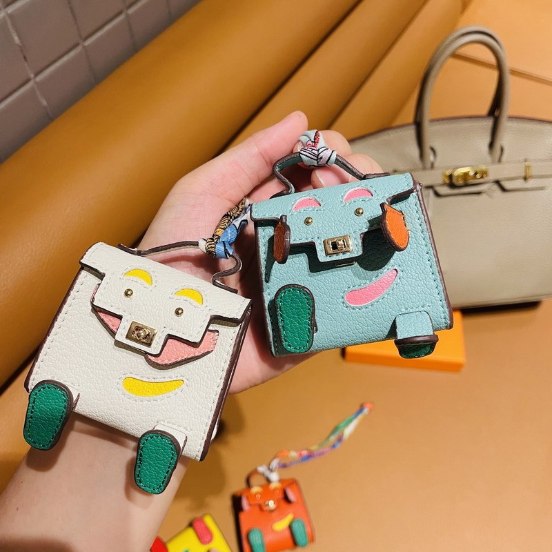 H家の同じタイプのminiキャリーの子供のカバンはかわいい怪獣のイヤーカバンの自動車のキーホルダーの車のペンダントを包みます。|undefined