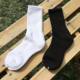 Summer solid color Joker black and white men's and women's sports high stockings simple cotton soft men's socks Zhuji socks wholesale