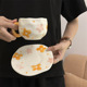 Orange flower cup and saucer
