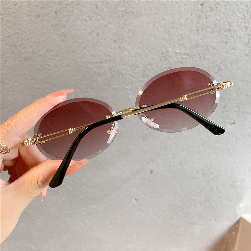 Nuevas gafas de sol transfronterizas para mujer, gafas de sol con degradado rojo ovalado en red, sin marco, gafas de moda al por mayor_voghion.com