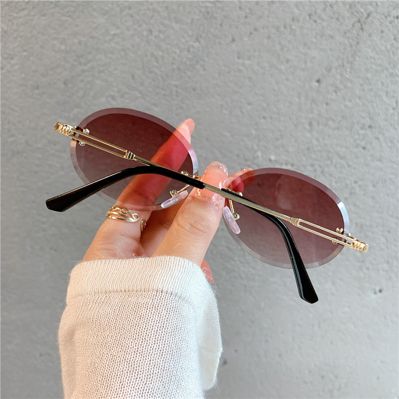 Nuevas gafas de sol transfronterizas para mujer, gafas de sol con degradado rojo ovalado en red, sin marco, gafas de moda al por mayor_voghion.com