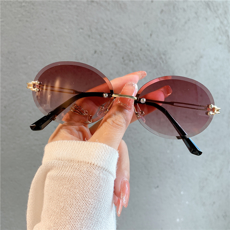 Nuevas gafas de sol transfronterizas para mujer, gafas de sol con degradado rojo ovalado en red, sin marco, gafas de moda al por mayor_voghion.com