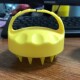 Yellow shampoo brush with short teeth
