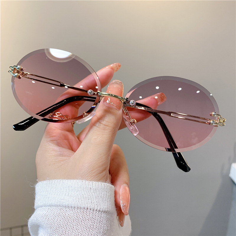 Nuevas gafas de sol transfronterizas para mujer, gafas de sol con degradado rojo ovalado en red, sin marco, gafas de moda al por mayor_voghion.com