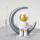 Plastic silver moon gold face astronaut