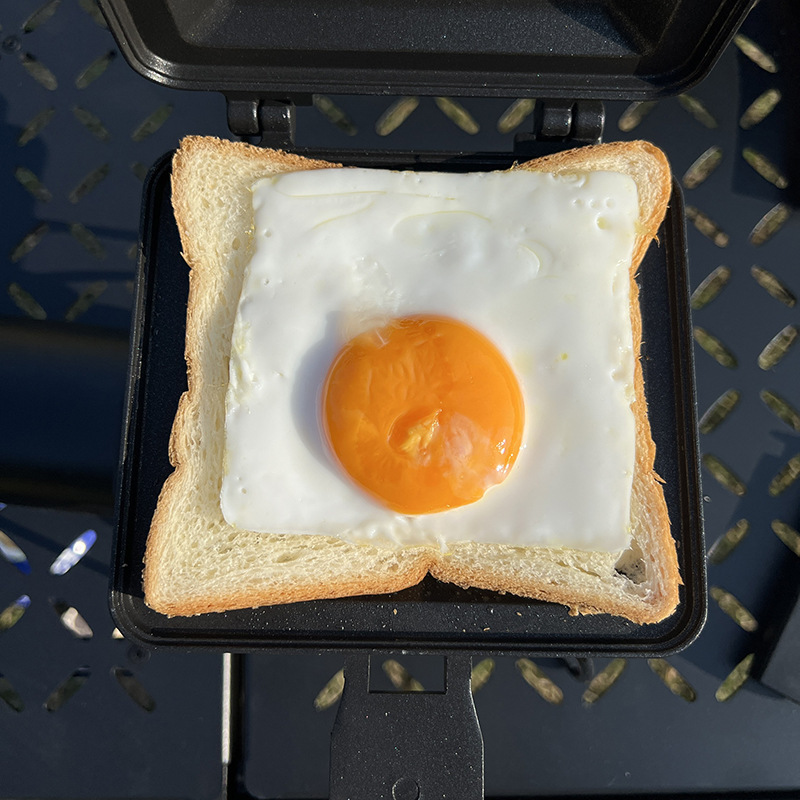 戸外キャンプ折り畳み携帯サンドイッチは日本式トースト両面フライパンにコーティングされた焼き皿を挟んでいる|undefined