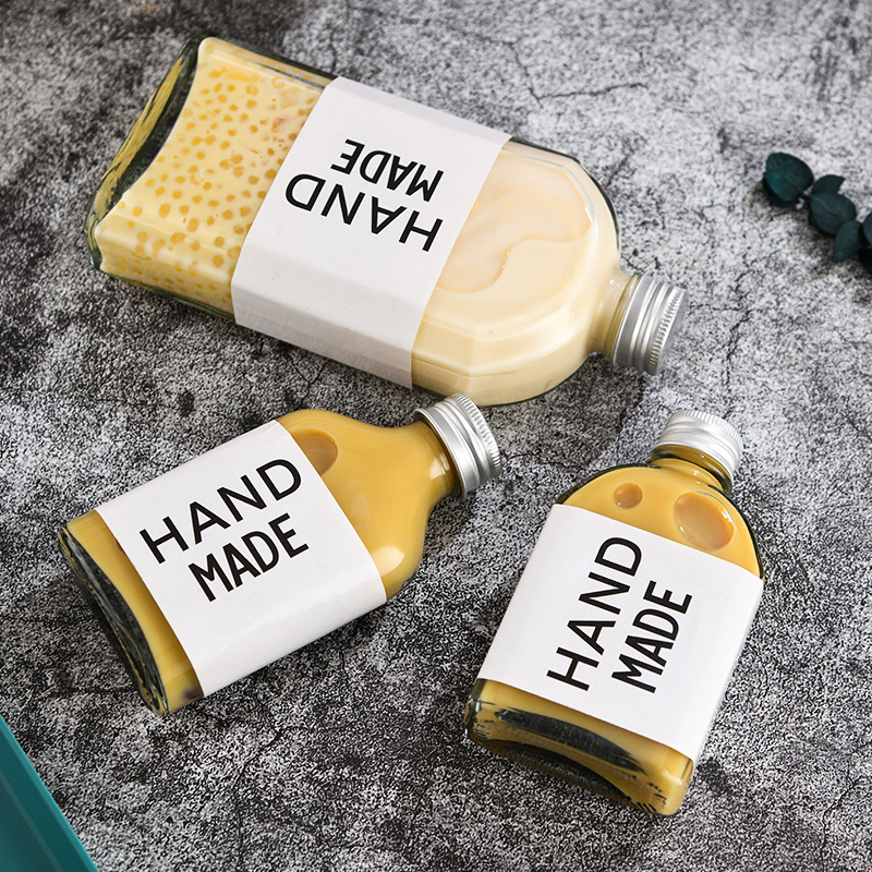 Cross-border glass beverage bottle milk tea bottle empty small wine bottle coffee cold extract bottle sealed fruit wine bottle oblique shoulder flat bottle wholesale