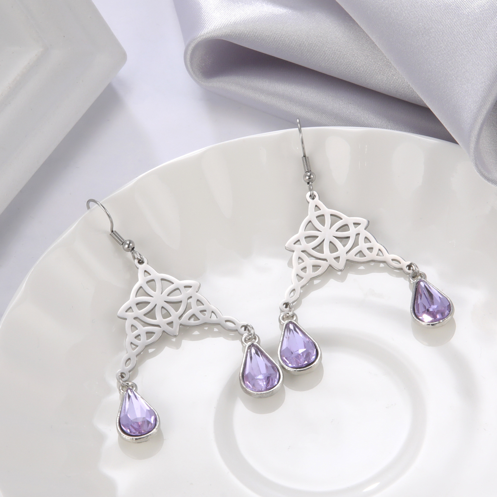 Titanium steel ear hook hollow double knot four leaf small round pendant manufacturer direct sales of stainless steel women's earrings