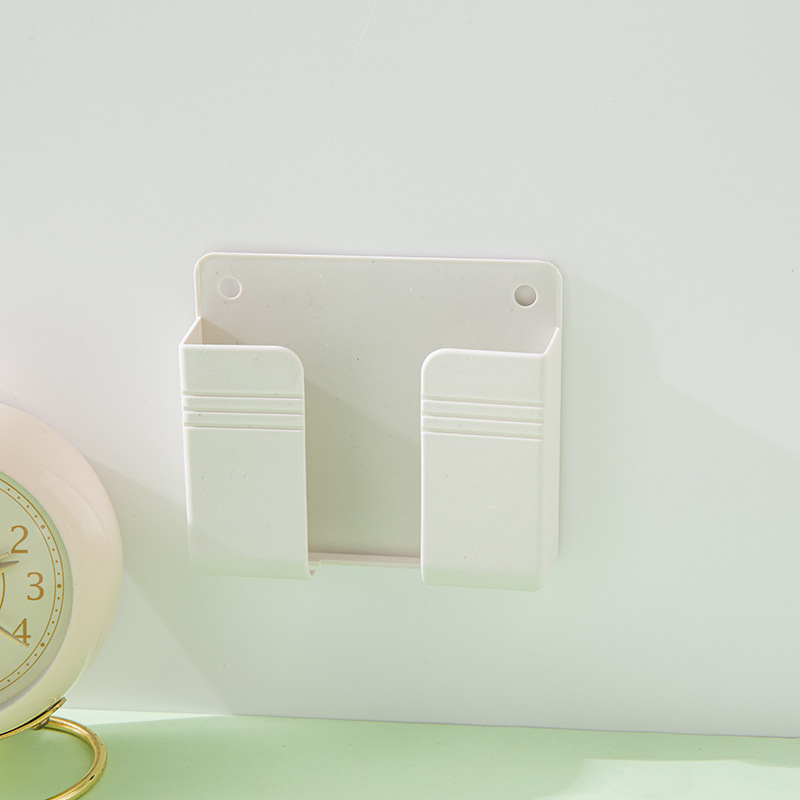 Wall-mounted mobile phone charging box bracket paste remote control base punch-free wall storage rack base wholesale
